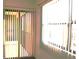 Balcony view features white vertical blinds, open windows and a screen door at 5400 Park N St # 200, St Petersburg, FL 33709