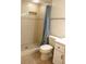 Bathroom featuring tiled shower with a blue curtain, a toilet, and vanity with storage at 5400 Park N St # 200, St Petersburg, FL 33709