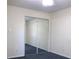 Bedroom with mirrored closet doors and neutral walls and carpeting at 5400 Park N St # 200, St Petersburg, FL 33709