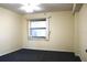 Basic bedroom featuring neutral walls, carpeted floor, and a window with vertical blinds at 5400 Park N St # 200, St Petersburg, FL 33709