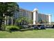 Multi-story condo building featuring balconies and parking with tropical landscaping in a sunny setting at 5400 Park N St # 200, St Petersburg, FL 33709