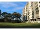 Beautiful exterior view of the multi-story condo complex surrounded by lush landscaping and manicured lawns at 5400 Park N St # 200, St Petersburg, FL 33709