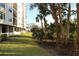 View of the building's manicured lawn with tropical trees and shrubs at 5400 Park N St # 200, St Petersburg, FL 33709