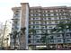 Multi-story condo building with balconies, stone accents, and tropical landscaping at 5400 Park N St # 200, St Petersburg, FL 33709