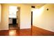 Living room featuring hardwood floors and view into kitchen at 5400 Park N St # 200, St Petersburg, FL 33709