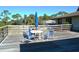 Enjoy outdoor dining on this deck with a table and chairs under the clear blue sky at 5400 Park N St # 200, St Petersburg, FL 33709