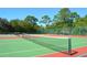 Two well-maintained tennis courts with a backdrop of lush, green trees at 5400 Park N St # 200, St Petersburg, FL 33709