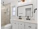 Bathroom boasts a white vanity with double sinks, and a tiled walk-in shower at 5426 Creeping Hammock Dr, Sarasota, FL 34231