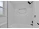 Updated bathroom features modern fixtures, white subway tile, and a recessed storage niche at 5426 Creeping Hammock Dr, Sarasota, FL 34231