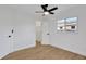 Bedroom features wood flooring, ceiling fan, and a doorway to a closet at 5426 Creeping Hammock Dr, Sarasota, FL 34231
