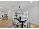 Elegant dining room featuring modern light fixture, dark wood table, and views to the entryway at 5426 Creeping Hammock Dr, Sarasota, FL 34231