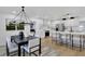 Open-concept dining area with modern chandelier, hardwood floors, and seamless access to the kitchen at 5426 Creeping Hammock Dr, Sarasota, FL 34231