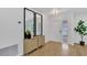 Bright foyer features modern console table, large mirrors, and a decorative light fixture at 5426 Creeping Hammock Dr, Sarasota, FL 34231