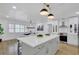 Modern kitchen with stainless appliances, white cabinets, and island with stool seating at 5426 Creeping Hammock Dr, Sarasota, FL 34231