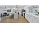 Bright, open-concept kitchen with white cabinetry, stainless appliances, and spacious countertops, flowing into the dining area at 5426 Creeping Hammock Dr, Sarasota, FL 34231