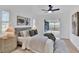 Modern main bedroom featuring a comfortable bed, fan, and slider to the lanai at 5426 Creeping Hammock Dr, Sarasota, FL 34231