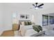 Modern main bedroom featuring a comfortable bed, fan, and slider to the lanai at 5426 Creeping Hammock Dr, Sarasota, FL 34231