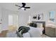 Modern main bedroom featuring a comfortable bed, fan, and shuttered windows at 5426 Creeping Hammock Dr, Sarasota, FL 34231