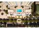 Aerial view of a luxurious rooftop pool, surrounded by landscaping and seating at 628 Cleveland St # 1507, Clearwater, FL 33755