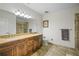 Bathroom showcasing a double vanity with granite countertops and a walk-in shower at 628 Cleveland St # 1507, Clearwater, FL 33755