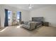 Bright main bedroom with large windows, carpeted floors, and a seating area at 628 Cleveland St # 1507, Clearwater, FL 33755