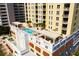 Stunning aerial view showcasing the rooftop pool and lounge area with palm trees at 628 Cleveland St # 1507, Clearwater, FL 33755