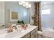 This primary bathroom features double sinks, a large mirror, and a decorative shower curtain at 746 Steel Dr, Apollo Beach, FL 33572