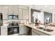Modern kitchen with stainless steel appliances and granite counter tops at 746 Steel Dr, Apollo Beach, FL 33572