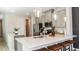 Bright kitchen featuring an island with a sink, pendant lighting, and stainless steel appliances at 746 Steel Dr, Apollo Beach, FL 33572