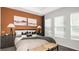The main bedroom features an accent wall, neutral linens, and plenty of natural light at 746 Steel Dr, Apollo Beach, FL 33572
