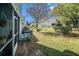 View of a spacious backyard featuring a well-manicured lawn and mature trees, offering ample space for outdoor activities at 7501 Hollowell Dr, Tampa, FL 33615