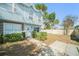 Inviting townhome exterior showcasing manicured landscaping, a brick-accented walkway, and light blue siding at 7501 Hollowell Dr, Tampa, FL 33615