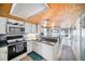 Functional kitchen with white cabinetry, stainless steel appliances, and convenient breakfast bar at 7501 Hollowell Dr, Tampa, FL 33615