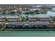 Aerial view showcasing waterfront condominiums surrounded by lush landscaping and scenic waterways, offering a serene living environment at 7560 Bay Island S Dr # 144, South Pasadena, FL 33707