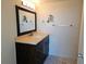 Bathroom with vanity, marble floors, and a framed mirror at 7560 Bay Island S Dr # 144, South Pasadena, FL 33707