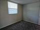 This bedroom features neutral walls, carpet, and a window with blinds for natural light at 7560 Bay Island S Dr # 144, South Pasadena, FL 33707