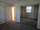 Bedroom featuring mirrored closet doors, neutral walls and carpets, and an exterior window at 7560 Bay Island S Dr # 144, South Pasadena, FL 33707