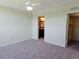 Bedroom featuring neutral carpeting, ceiling fan, and ensuite bath access at 7560 Bay Island S Dr # 144, South Pasadena, FL 33707