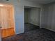 Bedroom featuring mirrored closet doors, neutral walls and carpets, and an exterior window at 7560 Bay Island S Dr # 144, South Pasadena, FL 33707