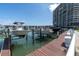 Boat dock with boats on lifts in front of a high-rise building at 7560 Bay Island S Dr # 144, South Pasadena, FL 33707