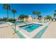 Community spa and hot tub area with lounge chairs surrounding on a bright day at 7560 Bay Island S Dr # 144, South Pasadena, FL 33707