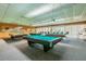 Large game room with multiple pool tables with a carpeted floor at 7560 Bay Island S Dr # 144, South Pasadena, FL 33707