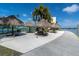 Scenic outdoor grilling area with tiki umbrellas and picnic tables near the water at 7560 Bay Island S Dr # 144, South Pasadena, FL 33707