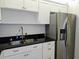 Kitchen showcasing stainless steel refrigerator, granite counters, and white shaker cabinets with ample storage at 7560 Bay Island S Dr # 144, South Pasadena, FL 33707
