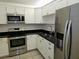 Kitchen featuring stainless steel appliances, shaker cabinets and granite countertops at 7560 Bay Island S Dr # 144, South Pasadena, FL 33707