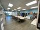 Bright library with tables and chairs, bookshelves, vending machine, and access to the outdoors at 7560 Bay Island S Dr # 144, South Pasadena, FL 33707