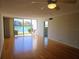 Living room offering laminate flooring, ceiling fan, natural light and sliding doors to a patio with tranquil water views at 7560 Bay Island S Dr # 144, South Pasadena, FL 33707