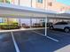 Designated covered parking spaces for residents with well-kept landscaping for shade at 7560 Bay Island S Dr # 144, South Pasadena, FL 33707
