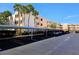 Covered parking for residents with lush landscaping on a bright, sunny day at 7560 Bay Island S Dr # 144, South Pasadena, FL 33707