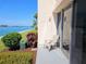 Enjoy water views from this condo patio with tropical plants and a sliding glass door at 7560 Bay Island S Dr # 144, South Pasadena, FL 33707